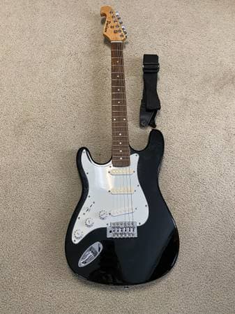 Davison left-handed Fender Stratocaster-style electric guitar with strap